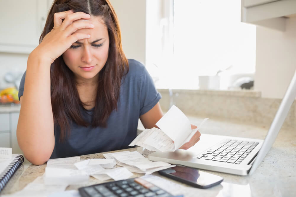 Woman worried analyzing receipts